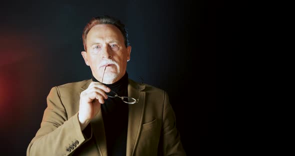 Portrait Elderly Man On Dark Background alt