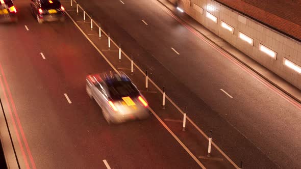 Timelapse of traffic entering an underpass at night