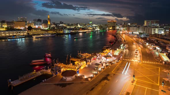 Night Timelapse of Old Dubai Creekside with Traditional Abras and Buildings. alt