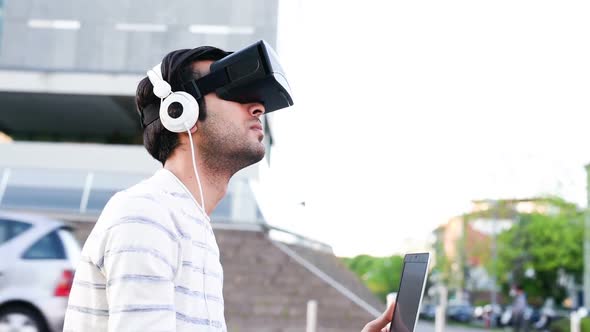 Young caucasian man using 3D viewer and pc alt