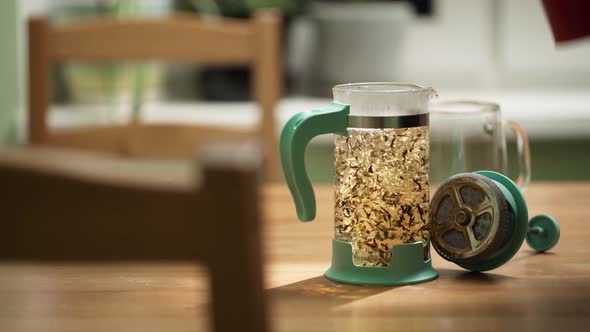 Unrecognizable Person Open and Put Dry Tea Leaves on Frenchpress