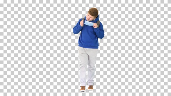 Teenager walking and taking off medical mask, Alpha Channel alt