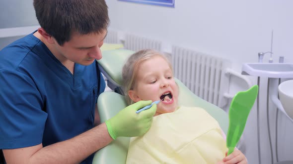 Child Girl Check Up and Dental Exam at Dentist