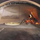 Cooking Pizza in a Woodburning Oven - VideoHive Item for Sale