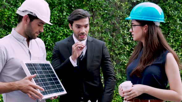 three engineers working looking new project with partnership about solar panel project together