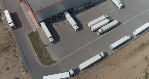 Buildings of Logistics Center, Warehouses in Field Near the Highway, View From Height, Trucks Near alt