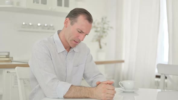 Stressed Middle Aged Man Getting Worried at Home alt
