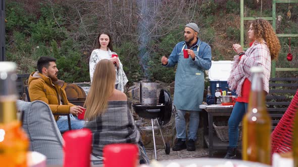 Friends Having a Barbecue Party in Backyard at Autumn