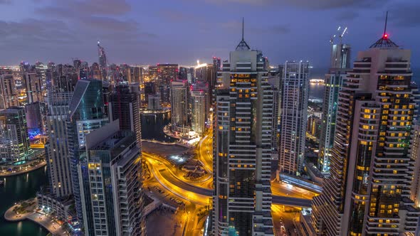Dubai Marina Skyscrapers and Jumeirah Lake Towers View From the Top Aerial Night to Day Timelapse in alt