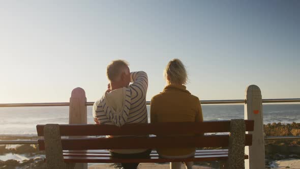 Senior couple embracing each other at beach alt