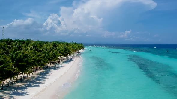 aerial take off along beautiful shore line of turquoise blue sea and palm trees on White beach, Pang alt