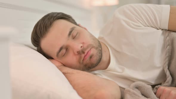 Portrait of Peaceful Young Man Sleeping in Bed alt