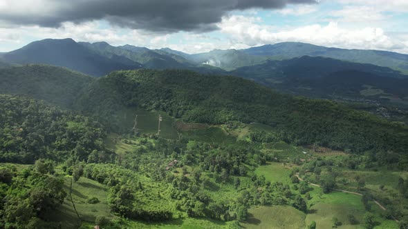 Aerial landscape view of greenery rainforest and hills by drone