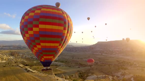 Aerial Hot Air Balloons Flying Over Hoodoos Fairy Chimneys in Cappadocia Turkey at Sunrise Morning alt