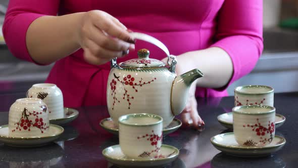 Hands of a Vietnamese Woman Prepares Traditional Vietnamese Tea