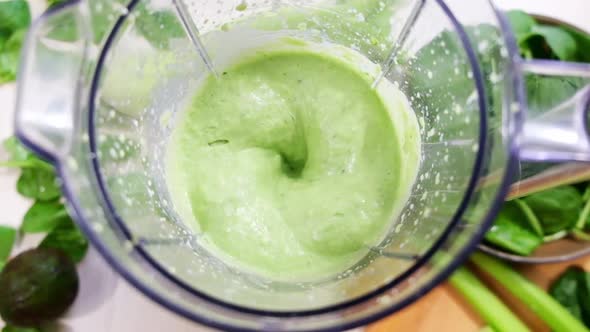 Green fresh smoothie blended in blender, top view. Healthy eating