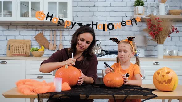 Mother with Daughter Making Jack-o-Lanterns alt