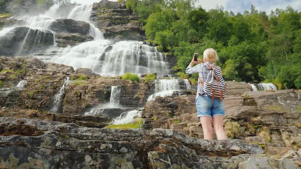 Womanphotographs the Highest Waterfall in Norway. According To Legend, the Water From This Waterfall alt