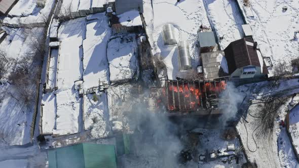 Top View of a House on Fire in a Village in Winter