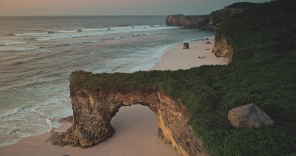 Indonesia Tourist Attraction Closeup Aerial Giant Hole on Cliff Wall of Batu Bolong Bawana Beach alt