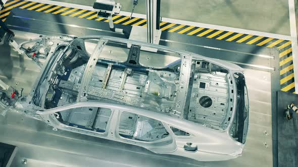 Top View of Car Body Framework at Car Factory. Automotive Factory Equipment. alt