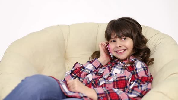 Little Girl Uses the Internet on a Smartphone Social Networks alt