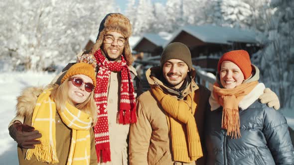 Portrait of Happy Friends in Park on Winter Day alt