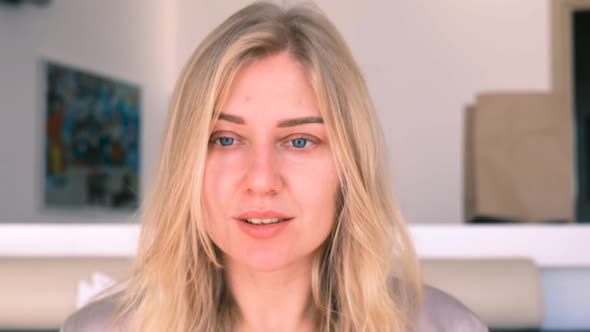 Confident Young Beautiful Blueeyed Blonde Woman Without Makeup Looks Into the Camera