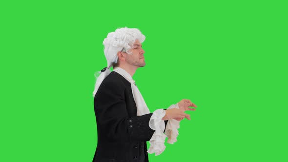 Man Dressed Like Mozart Conducting While Walking on a Green Screen, Chroma Key. alt