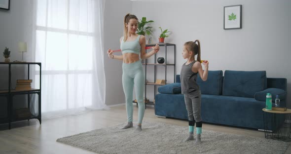 Slender Sporty Woman Is Training Her Little Daughter at Home Instilling Good Habits and Healthy alt