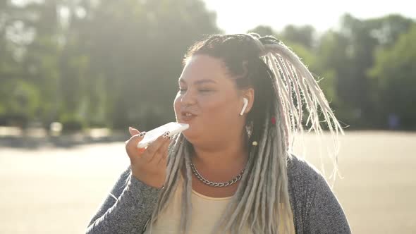 Creative Girl Using Recorder To Do Voice Search Online in Mobile Internet. Happy Fat Woman Recording alt