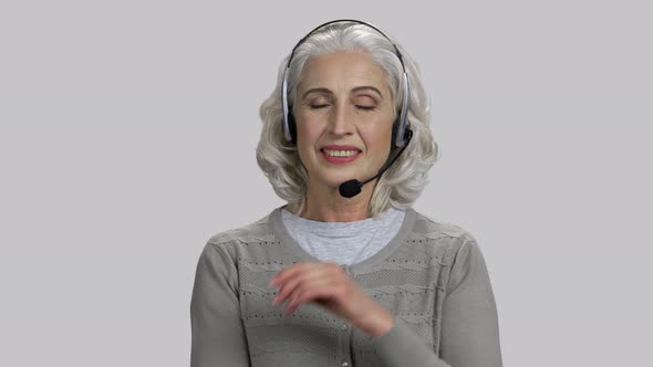 Pretty Senior Lady Wearing Headset and Smiling alt