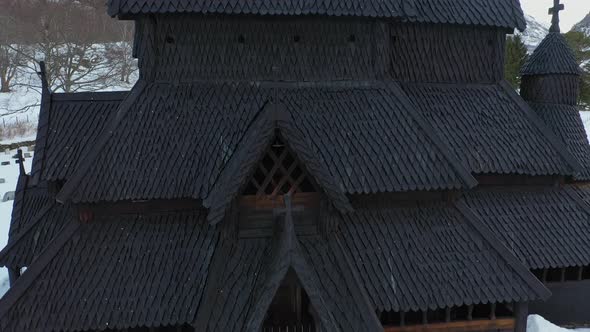 Borgund stave church from middle age - Detailed ascending aerial from entrance to top of tower alt