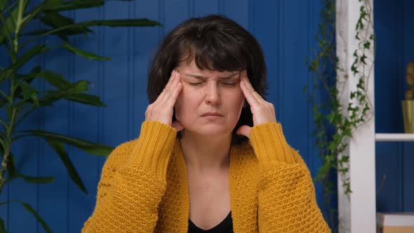 Middle Aged Woman Sitting and Have a Headache Because Migraine and Health Problem