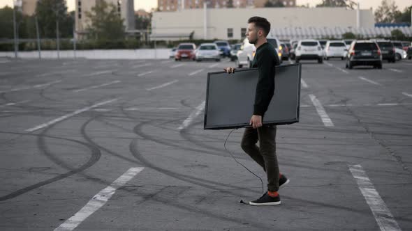 A Man Drops a New Purchased TV on a Supermarket Parking and Falls Unsuccessfully Delivers It to the alt