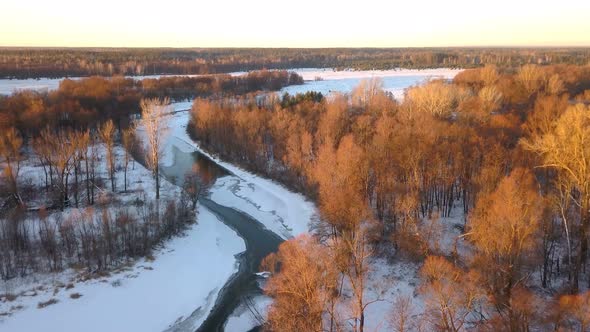 Winter Forest River At Sunset