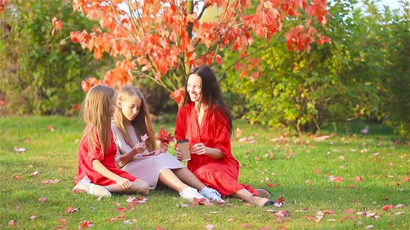 Little Girl with Mom Outdoors in Park at Autumn Day alt