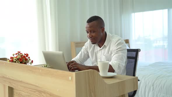 Smiling business black american man, African person working from home on table alt