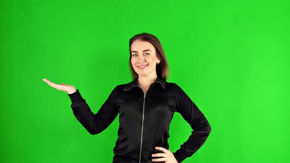 A Woman on a Green Background Holds Her Hand Palm Up