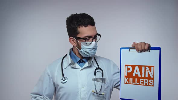 Physician Wearing a Stethoscope Holding a Clipboard with Text PAIN KILLERS alt