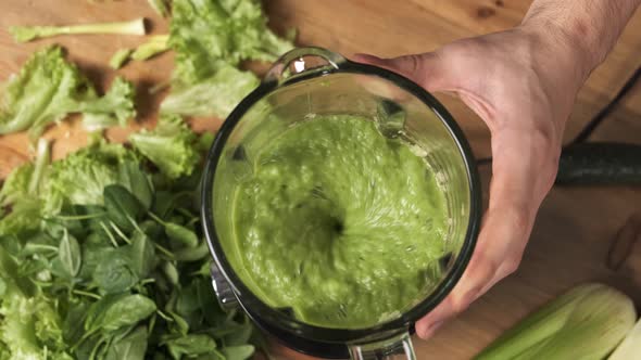 Making Green Juice at Home Male Hands Mixing Vegetable Smoothie in Glass Blender at Home Kitchen alt