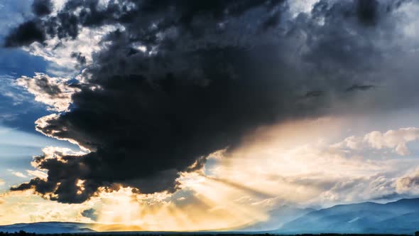 Majestic cloudscape time lapse at sunset with sunbeams
