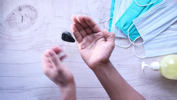 Top View of Young Man Hand Using Sanitizer Gel for Preventing Virus  alt