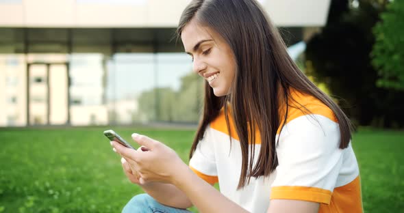 Smiling Woman with Smartphone Outdoors