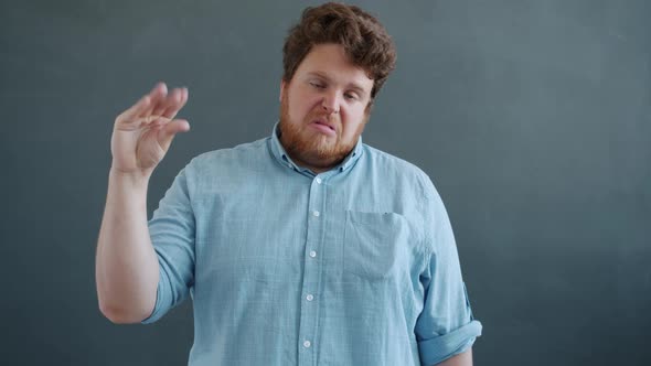 Slow Motion of Annoyed Man Showing Talking Hand Gesture and Saying Bla Bla Bla Then Closing Ears alt