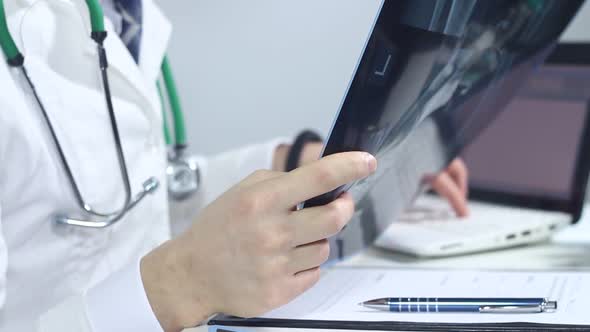 Doctor Radiologist Working In A Hospital Using A Laptop