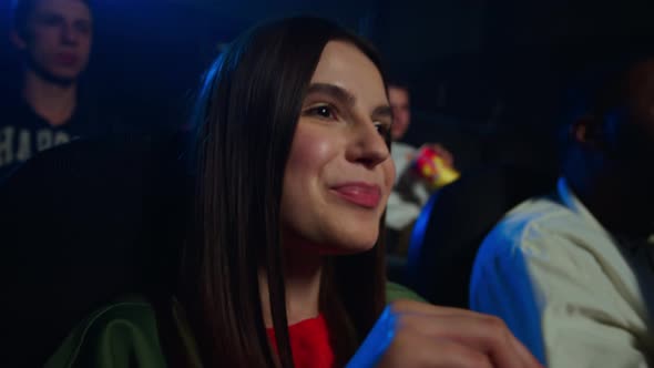 Joyful Woman Watching Film in Cinema. Friends Having Fun in Movie Theatre. alt