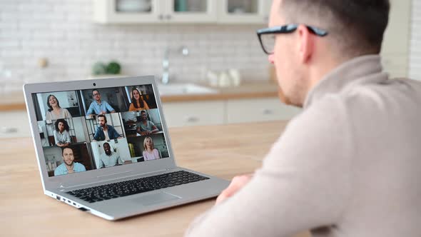 Young Businessman in Glasses Has Video Call on the Laptop alt