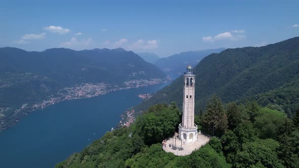 Aerial View Of The Faro Voltiano Overlooking Lake Como. Dolly Forward alt