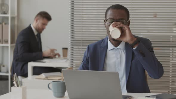 African American Broker Working on Laptop in Office alt